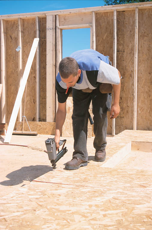A wooden wall structure is being framed, possibly for a building or home construction.